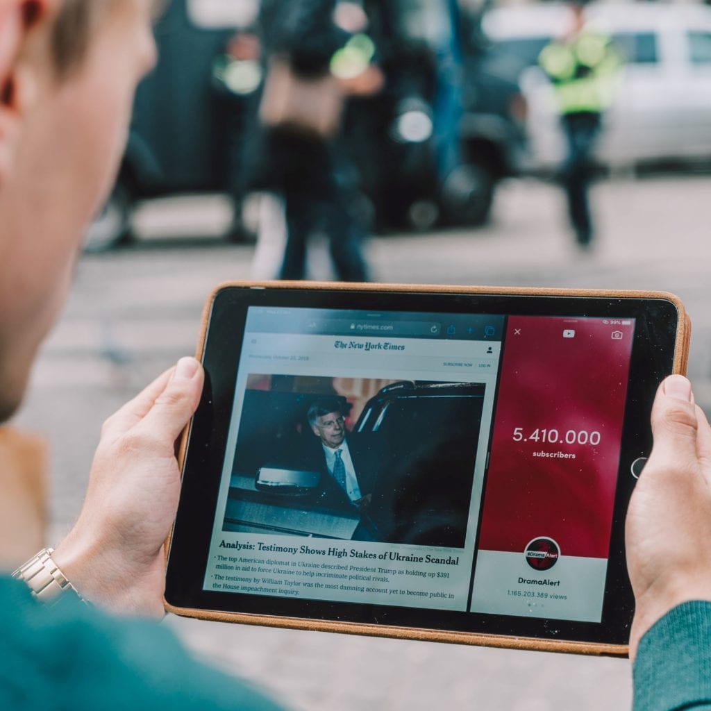 Person reading great web content on an electronic device.