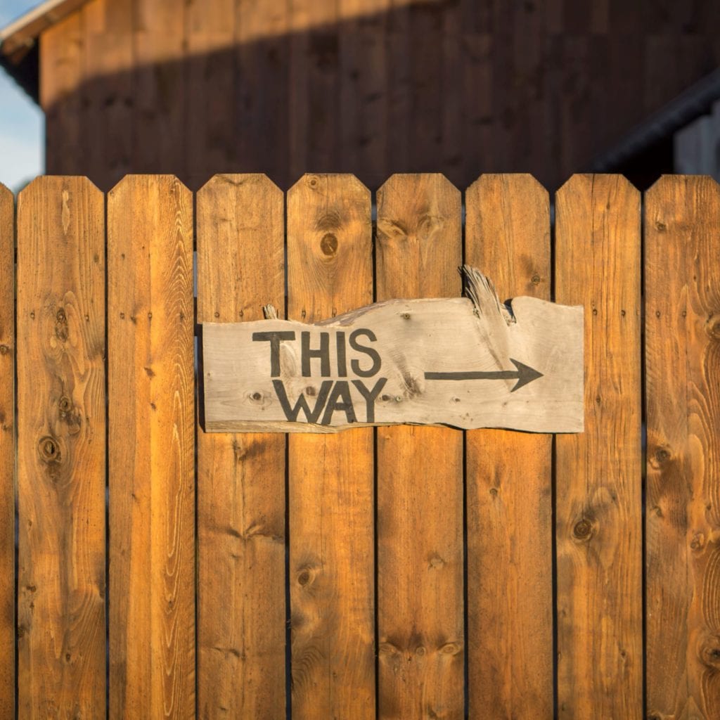 Fence with a sign saying: This Way.