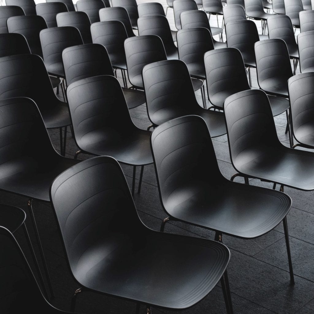 Black chairs lined up. 